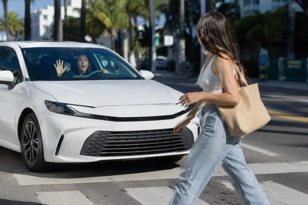 A driver failing to yield to a pedestrian crossing in a marked crosswalk