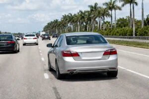 Car drifting over the dashed lane line toward another vehicle on a Florida highway in a lane departure accident