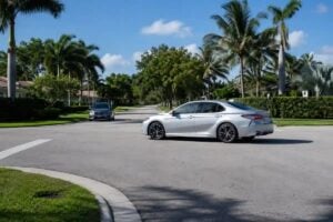 Two cars approaching an uncontrolled South Florida intersection where a T-bone accident at an intersection can happen